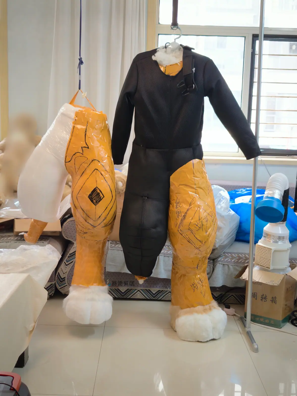 Duct-tape dummy for a custom fursuit bodysuit, with digitigrade leg padding and a mesh bodysuit