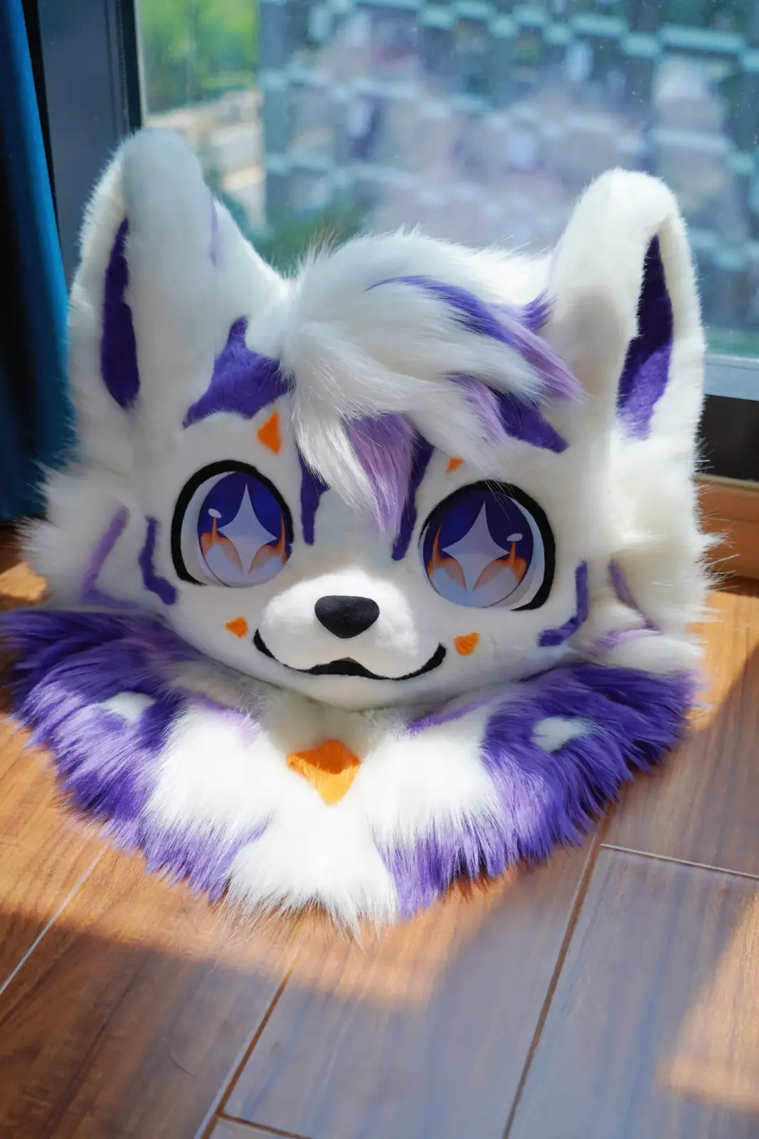 Kemono-style white and lavender wolf fursuit head with purple stripes, big violet anime eyes and an orange chest mark, front view