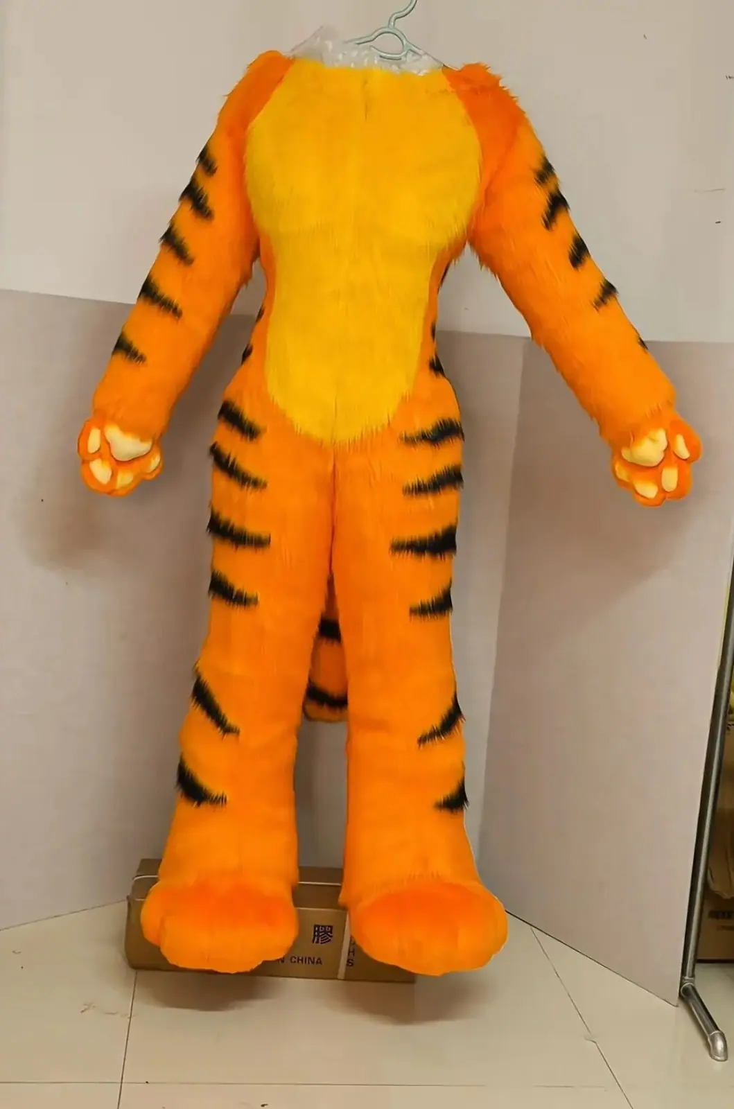 Orange tiger fursuit bodysuit with black stripes, a yellow belly and attached hand and feet paws, front view