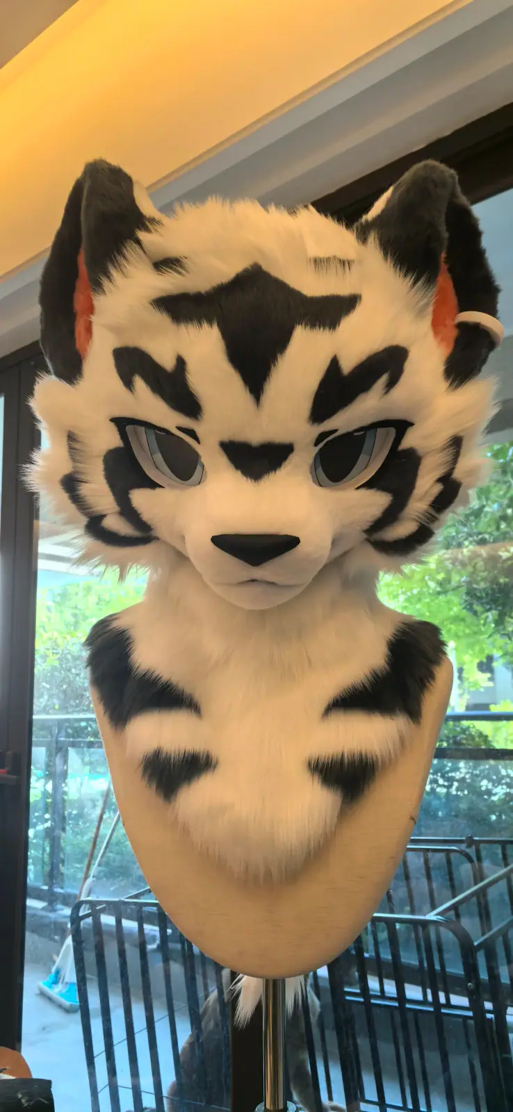 Toony-style tan tiger fursuit head with bold black stripes, front view