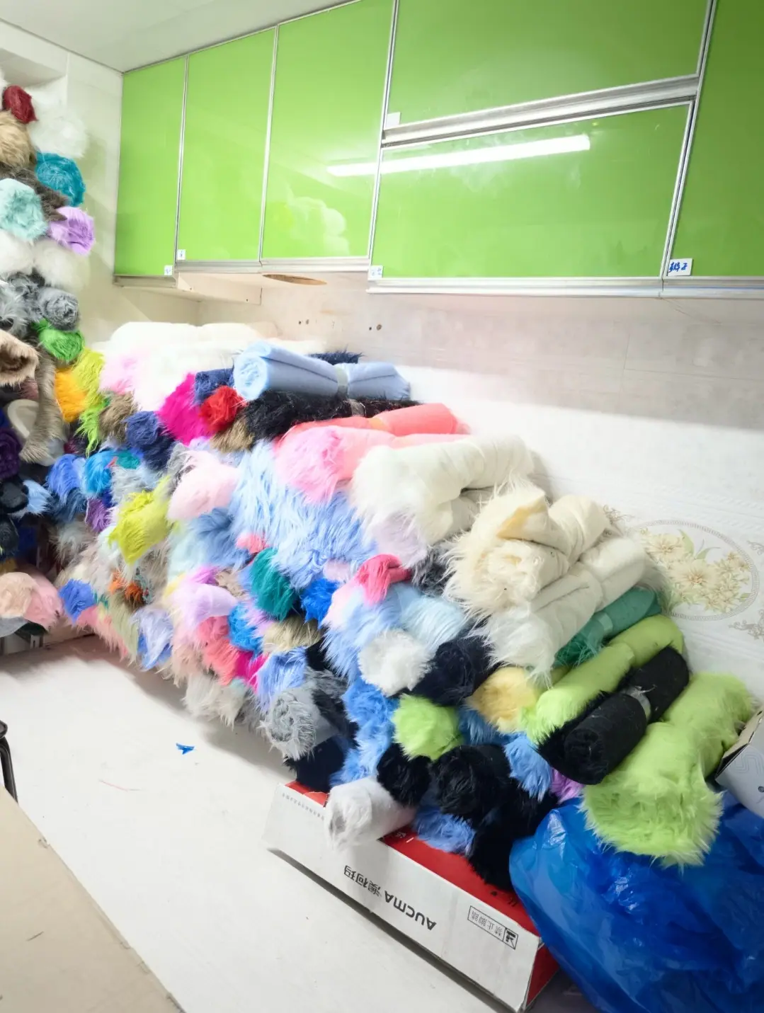 Our fursuit studio, with rolls of faux fur in every colour